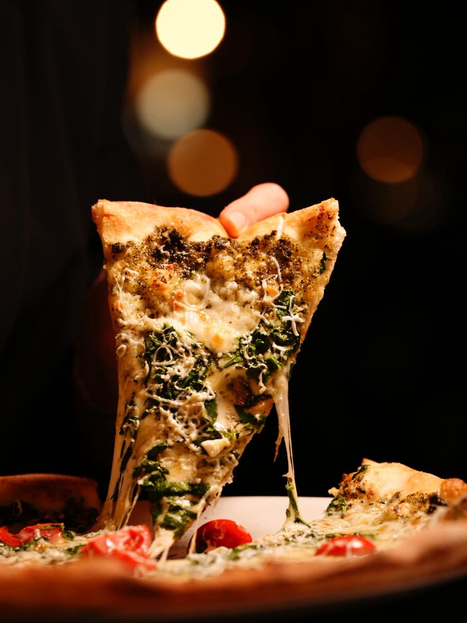 Fresh pizza with melted cheese at Corner Pizza and Grill